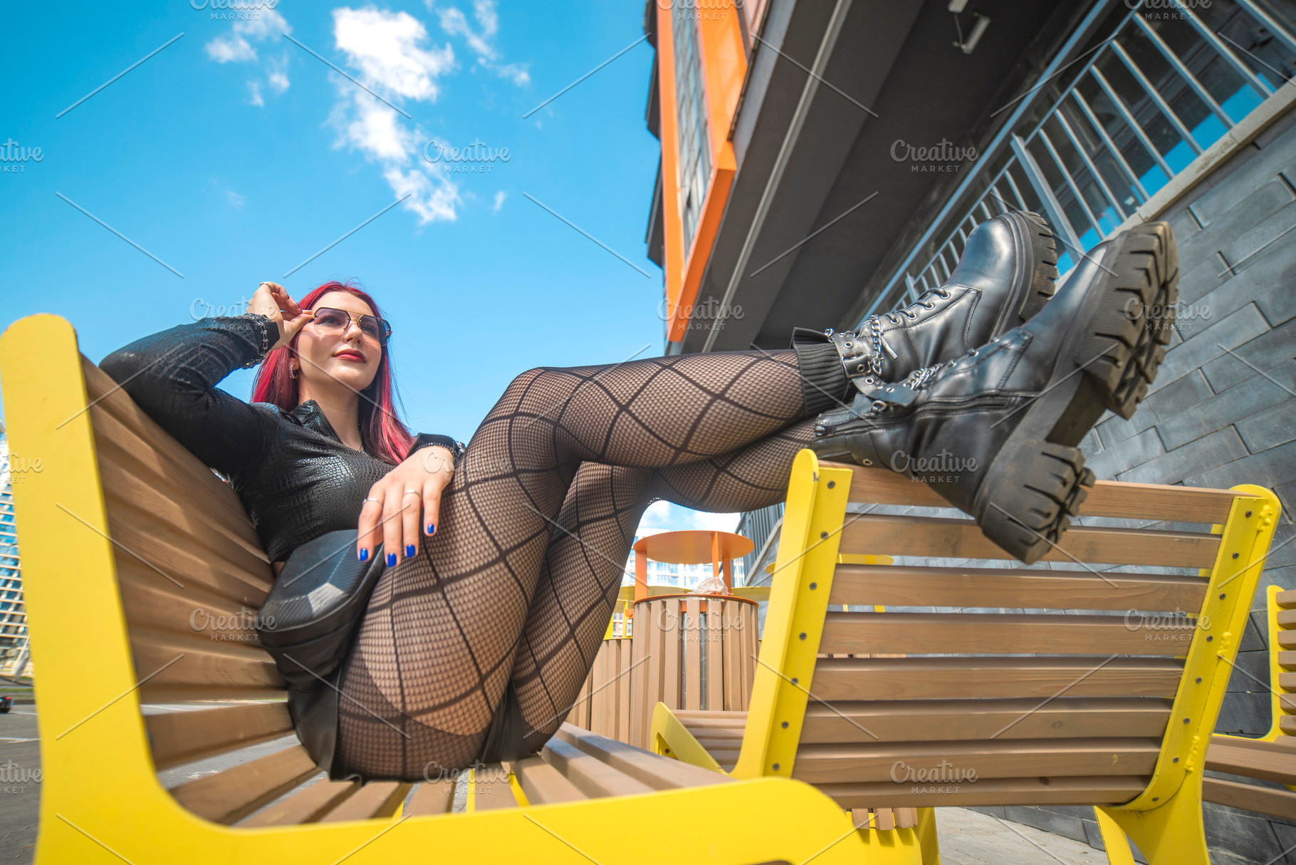 Edgy red haired girl in fishnet tights relaxing on yellow bench, a Photo by Pictures for you!!!!!!!!!