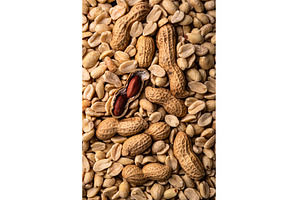 Pile of peanuts with one partially, a Food & Drink Photo by Yulia Furman
