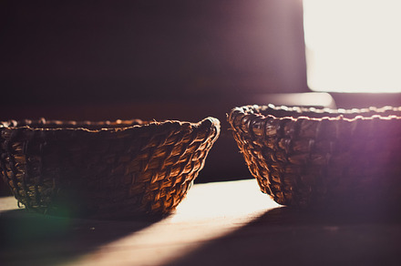 Rays of light containing sun flare, wicker basket, and bread, an Abstract Photo by Pro.Motion