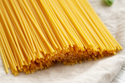 Raw Organic Spaghetti Pasta in a Bunch, side view., a Food & Drink Photo by LiudmylaChuhunova
