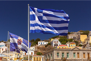 Greek Flag Flying Over Symi, Greece, a Nature Photo by kavalenkava