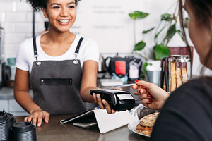 Smiling barista in apron, a Business Photo by Artem Varnitsin
