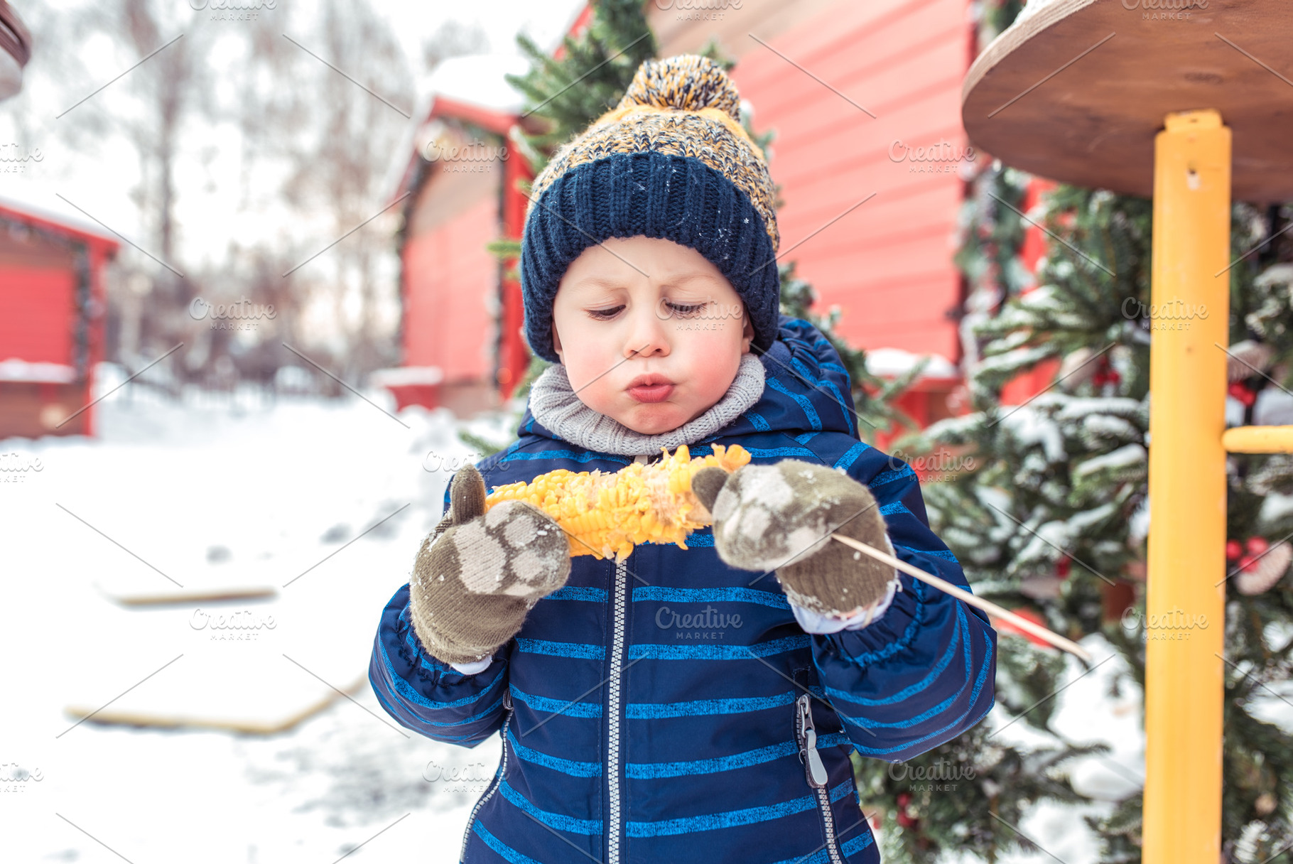 A little baby boy is eating boiled containing corn, hot, and eats, a Person Photo by byswat