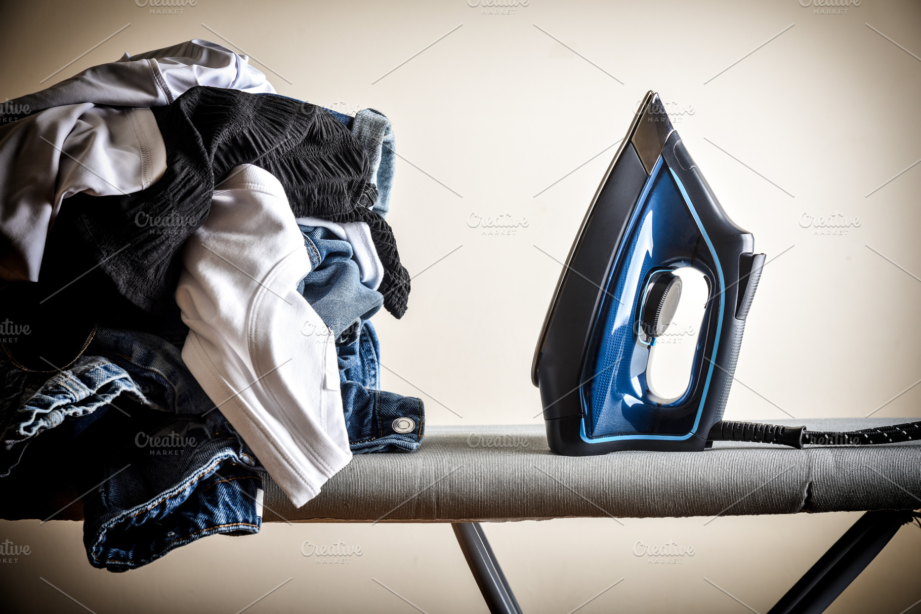 Hard work of ironing with board and pile of clothes, a Technology Photo by Davizro's Market