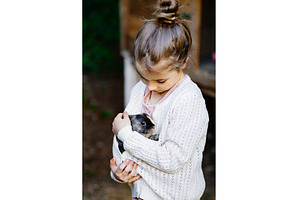 Young girl with pet rabbit sitting, an Animal Photo by HalfPoint