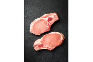 Raw pork meat steaks on black, a Food & Drink Photo by Nadia-nb