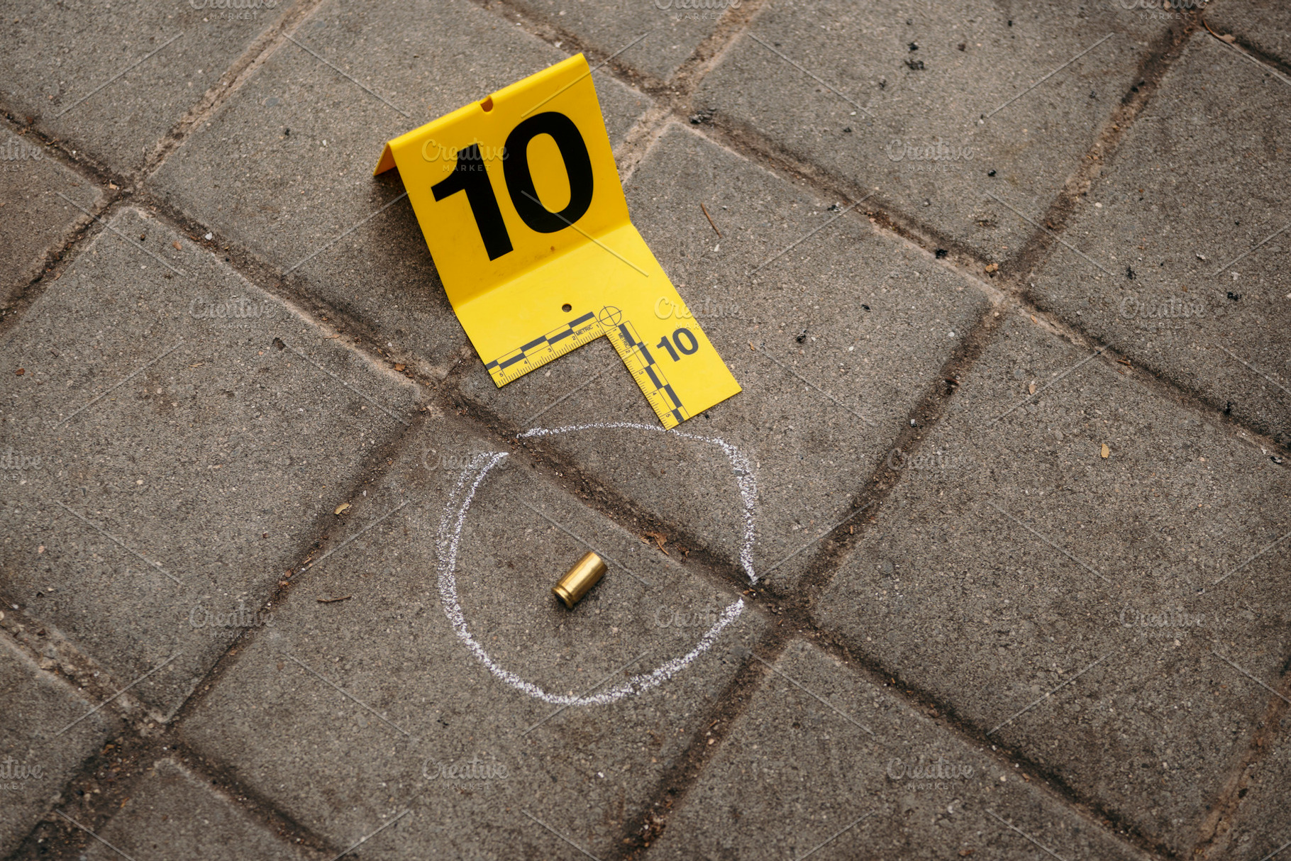 Crime scene evidence with bullet casing and forensic marker, an Industrial Photo by karrastock