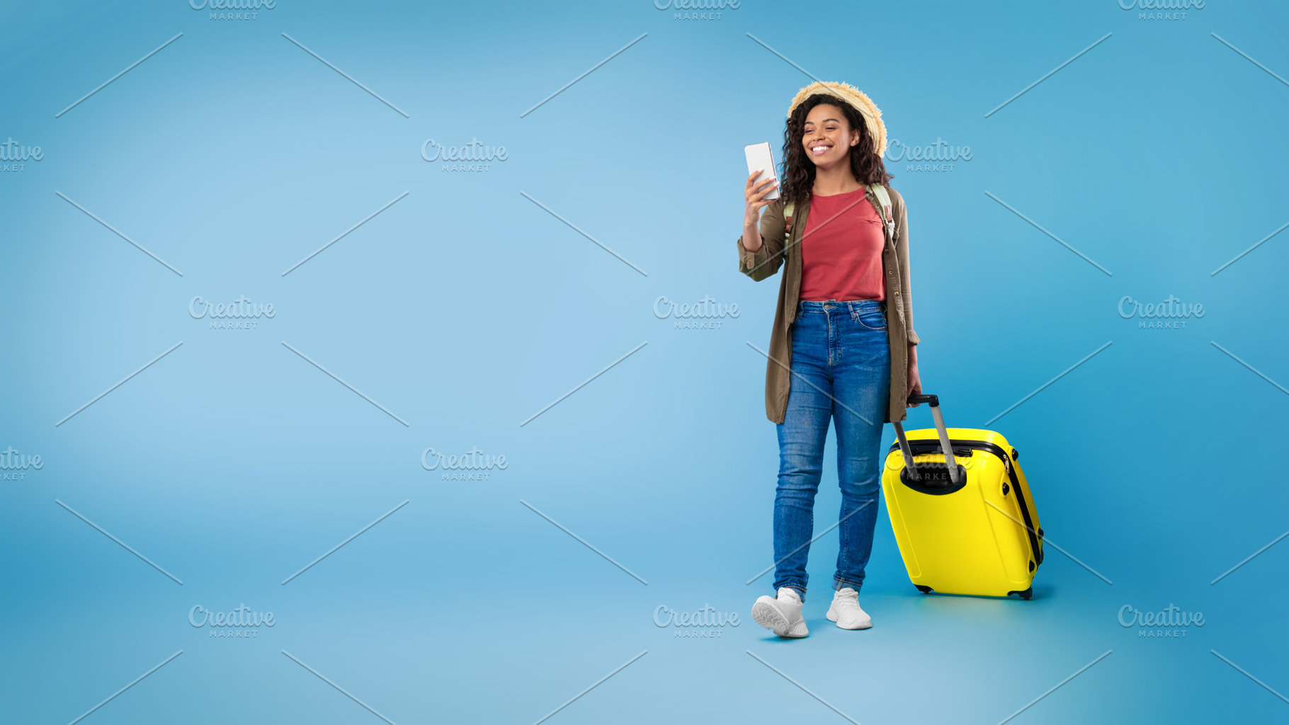Black female using cellphone, booking hotel or vacation on web, using online tr, a Photo by Prostock-Studio