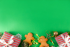 Christmas background with gingerbread man cookies, gifts and bau, a Photo by Rimma