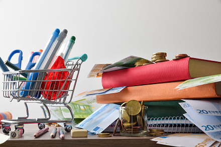 Concept cost of school supplies with shopping cart
