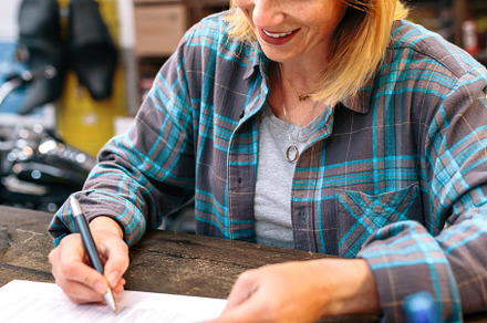 Portrait of smiling blonde young woman filling order forms for ecommerce shop, a Person Photo by davidpereiras