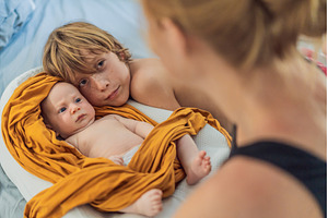 Older brother hugging his newborn, a Person Photo by Elizaveta Galitskaya