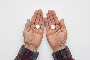 Mature hands with medicine pills, a Health & Medical Photo by AlyaAnd