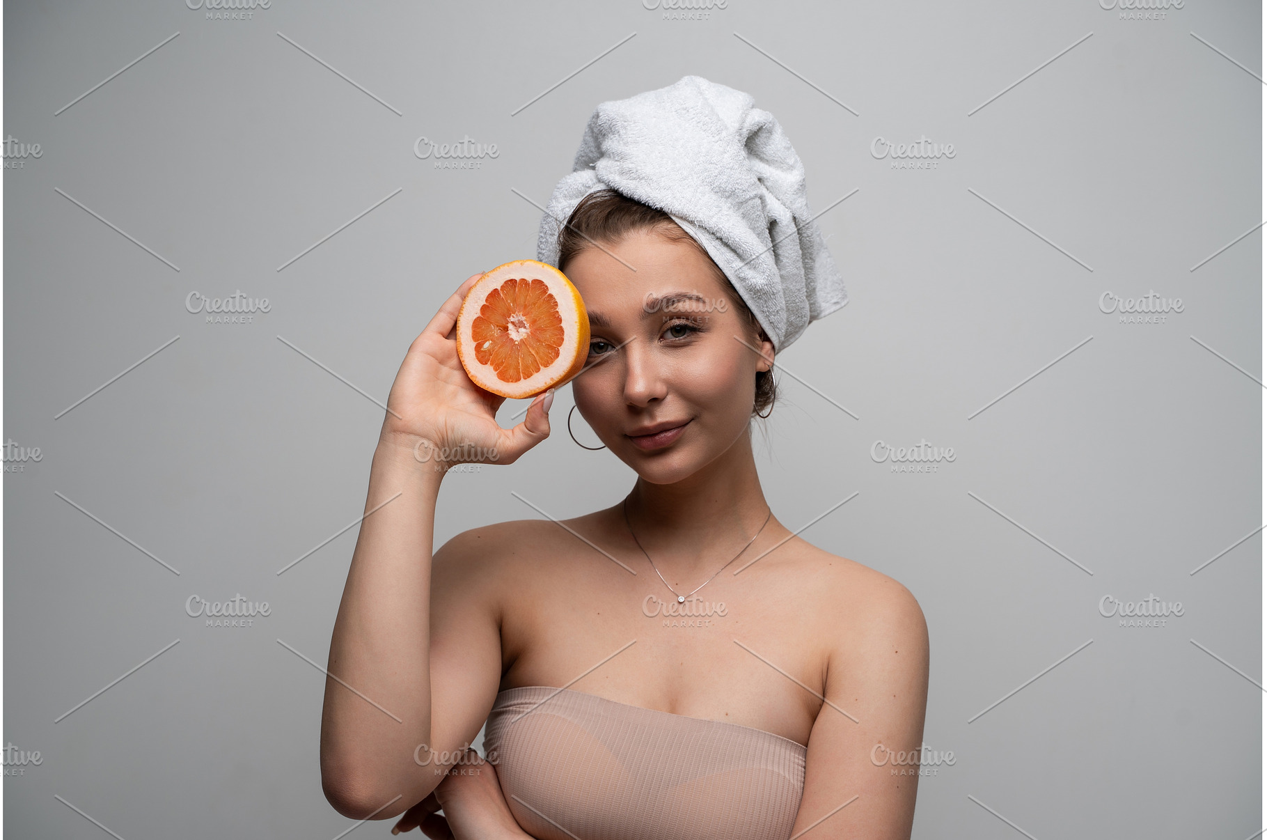 Young woman smiling, wearing a towel, a Health & Medical Photo by volodymyrshtun13795