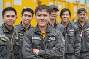 Team asian members in industrial uniforms standing together with a positive dem, an Industrial Photo by AS photostudio