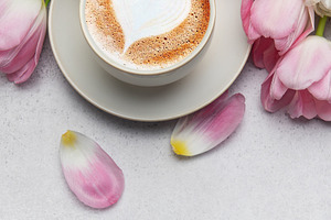 Cappuccino with heart shaped foam and pink tulips bouquet on gre, a Holiday Photo by Olena Rudo