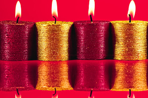 Red and gold candles with bright flames burning, casting reflect, a Photo by Studio ANNA