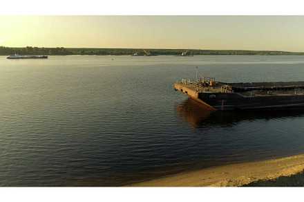 Cargo barge moored by the river, an Industrial Photo by Media Whale Stock