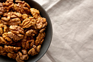 Raw Walnut Halfs in a Bowl, top view. Flat lay, overhead. Copy s, a Food & Drink Photo by LiudmylaChuhunova
