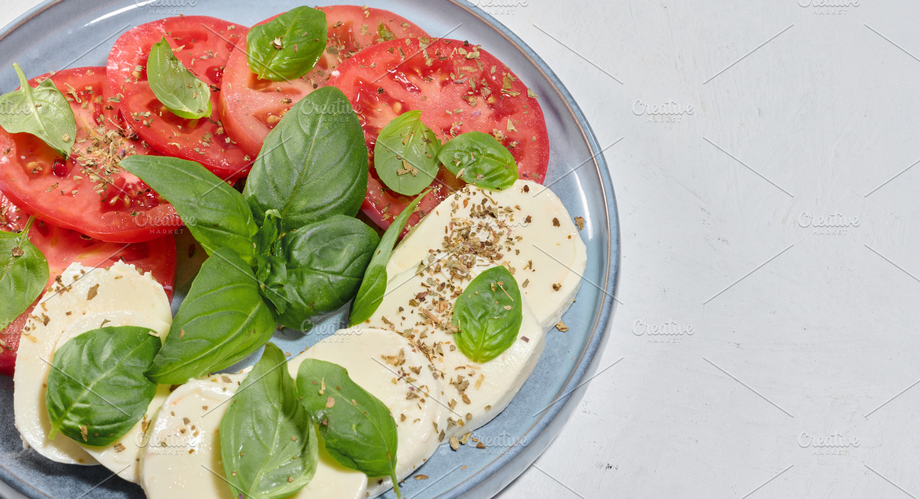 Classic Caprese salad with sliced fresh tomatoes, mozzarel, a Food & Drink Photo by ndanko