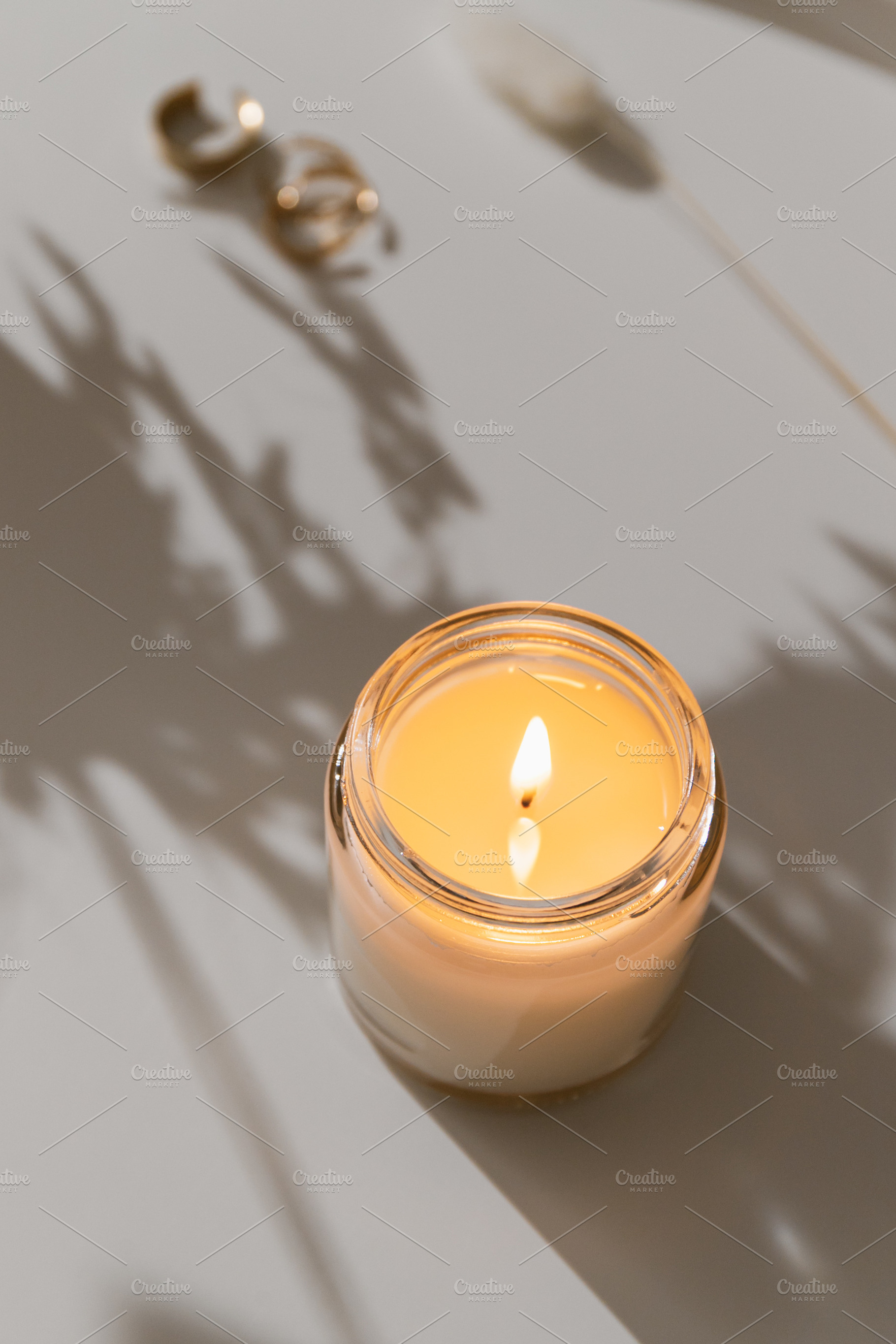 White burning candle on coffee table, an Arts & Entertainment Photo by Edalin's Store