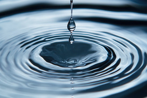 Droplet creates ripples of calm, a Photo by Pavel_design