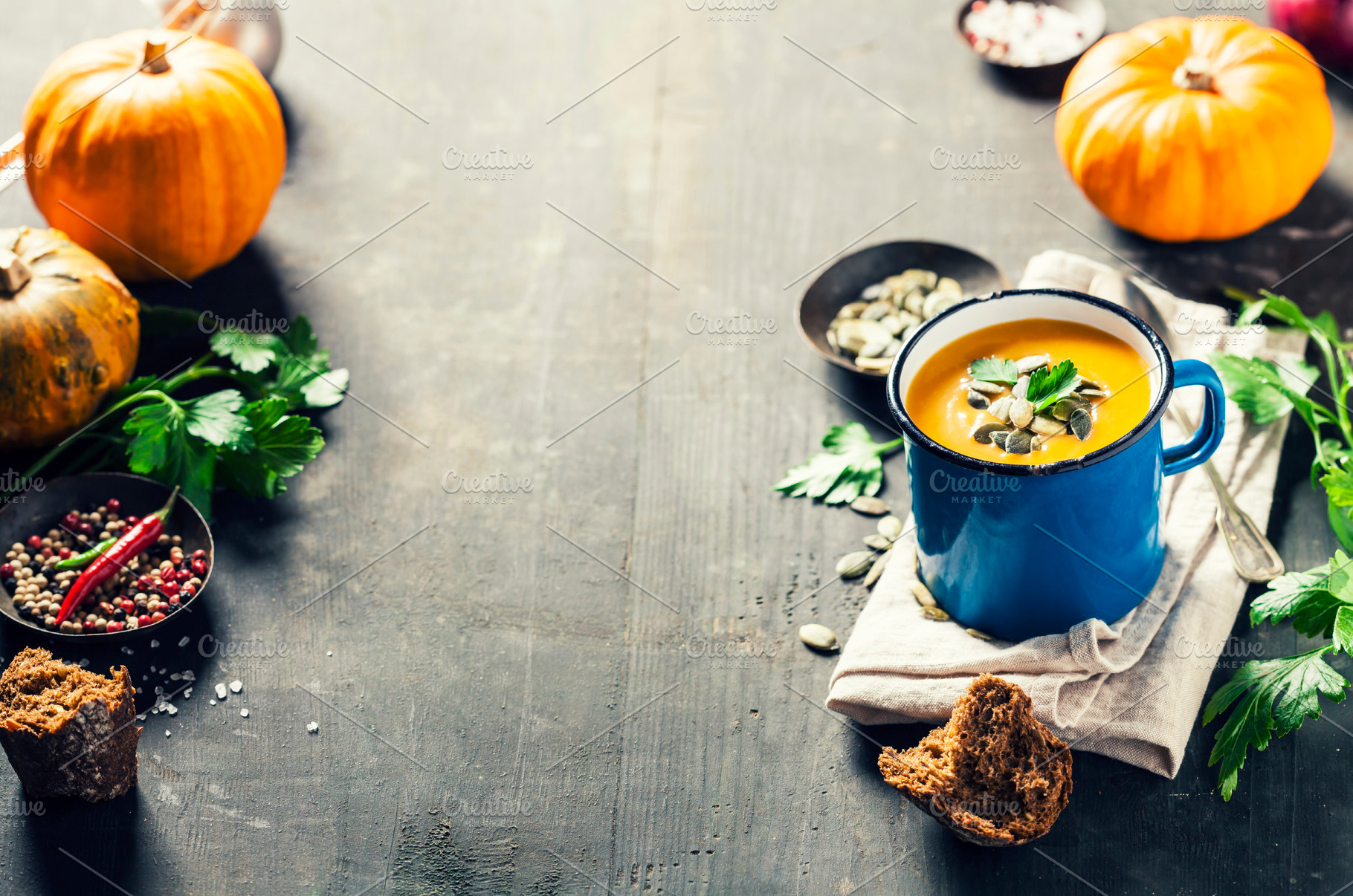 Pumpkin soup in a metal pot on a wooden surface and ingredients, a Food & Drink Photo by Natalia Klenova's Shop