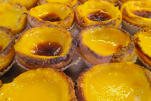 Portuguese custard tarts in bakery display, a Food & Drink Photo by DanFLCreativo