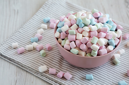 Rainbow Fruity Mini Marshmallows in a Pink Bowl, side view. Copy, a Food & Drink Photo by LiudmylaChuhunova