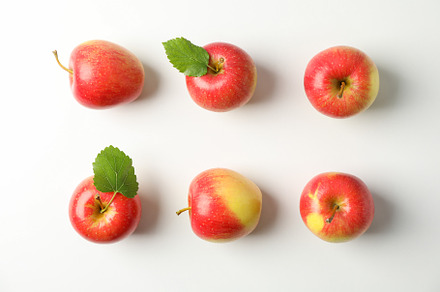 Flat lay with red apples on white background, space for text, a Food & Drink Photo by AtlasStudio