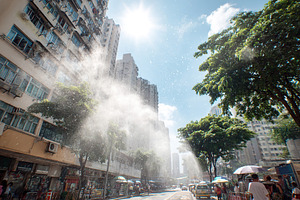 Urban street bustling with activity under the heat haze on a sunny day, a Photo by AlyaAnd