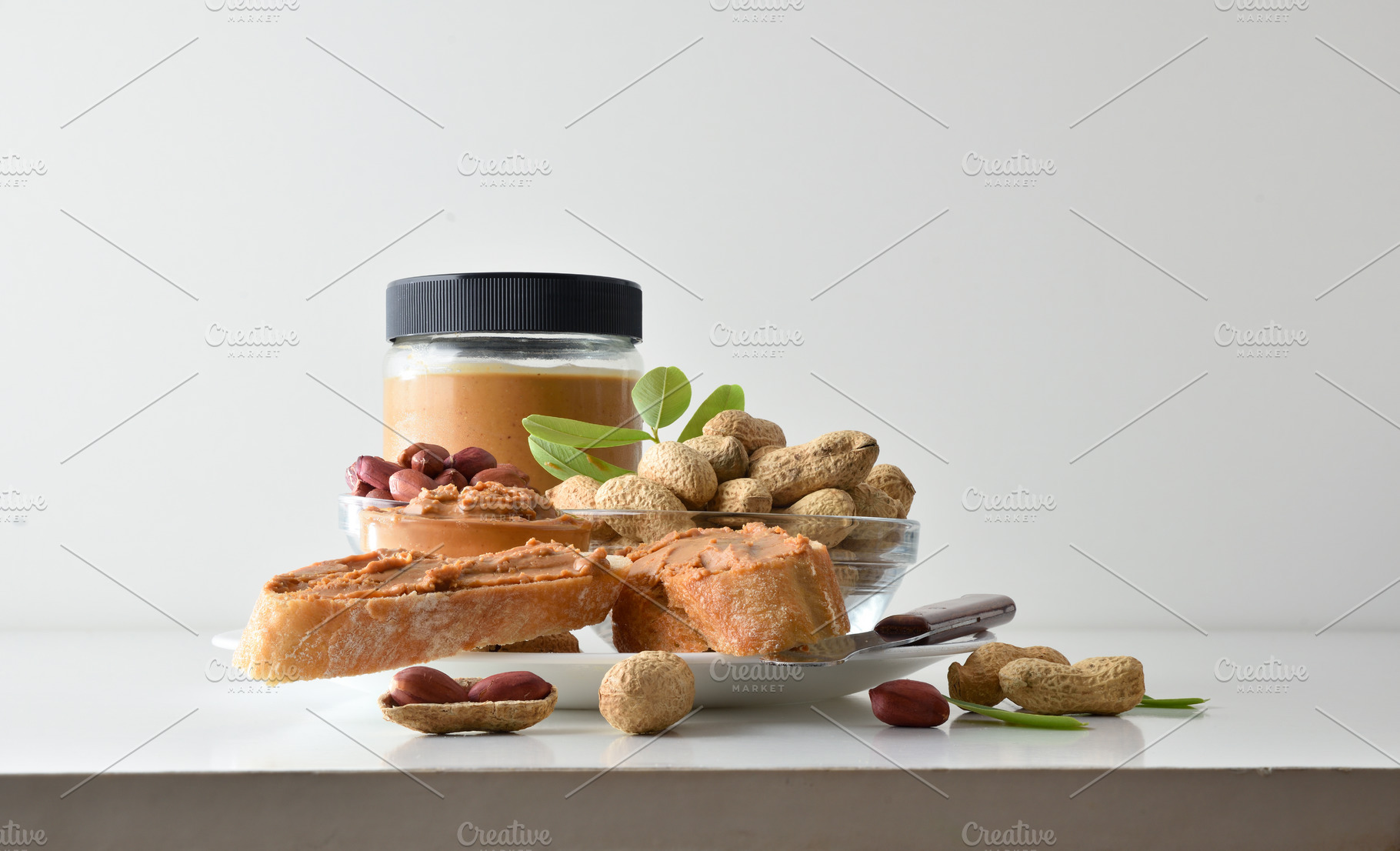 Bread with peanut butter isolated on white table and background, a Food & Drink Photo by Davizro's Market