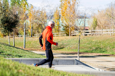Senior man running up stairs in an outdoor park setting, a Sports & Recreation Photo by RF Images