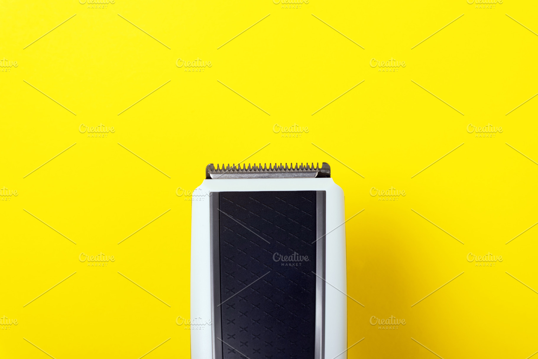 Top view of a black and white electric hair clipper on a bright, a Technology Photo by Ales Munt