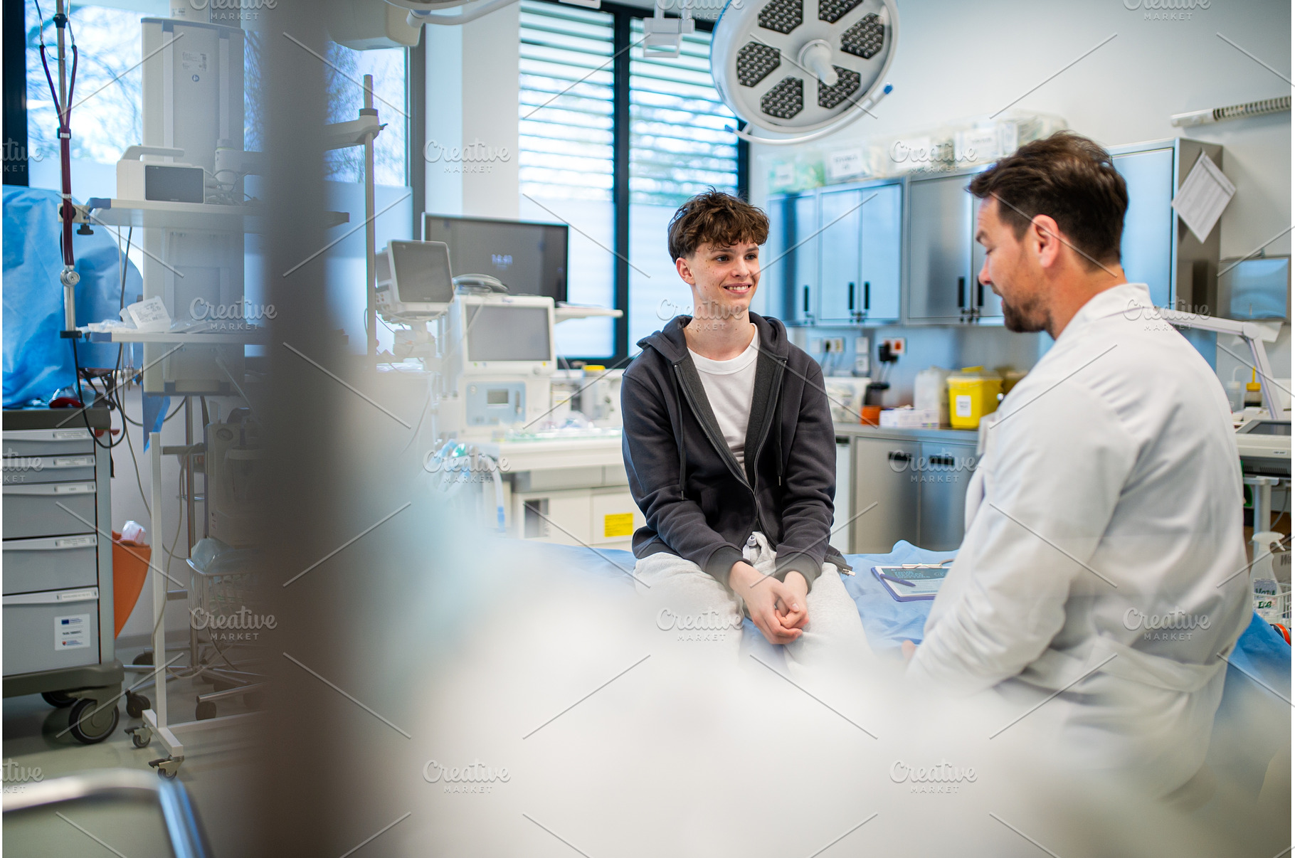 Teenage boy smiling during medical, a Sports & Recreation Photo by HalfPoint