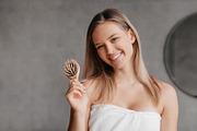 Happy young woman wrapped in white towel holding hair brush and smiling at came, a Photo by Prostock-Studio (Thumbnail 5 of 5)