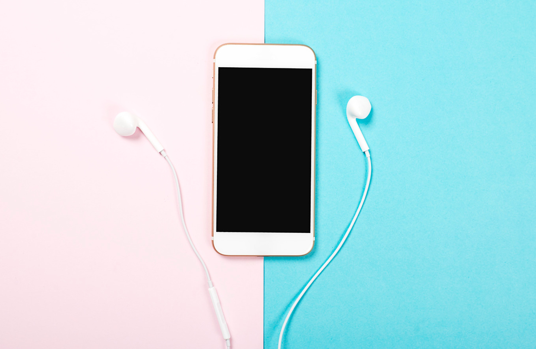 Smartphone and headphones on pink and blue background technology containing, a Technology Photo by José Luis Agudo