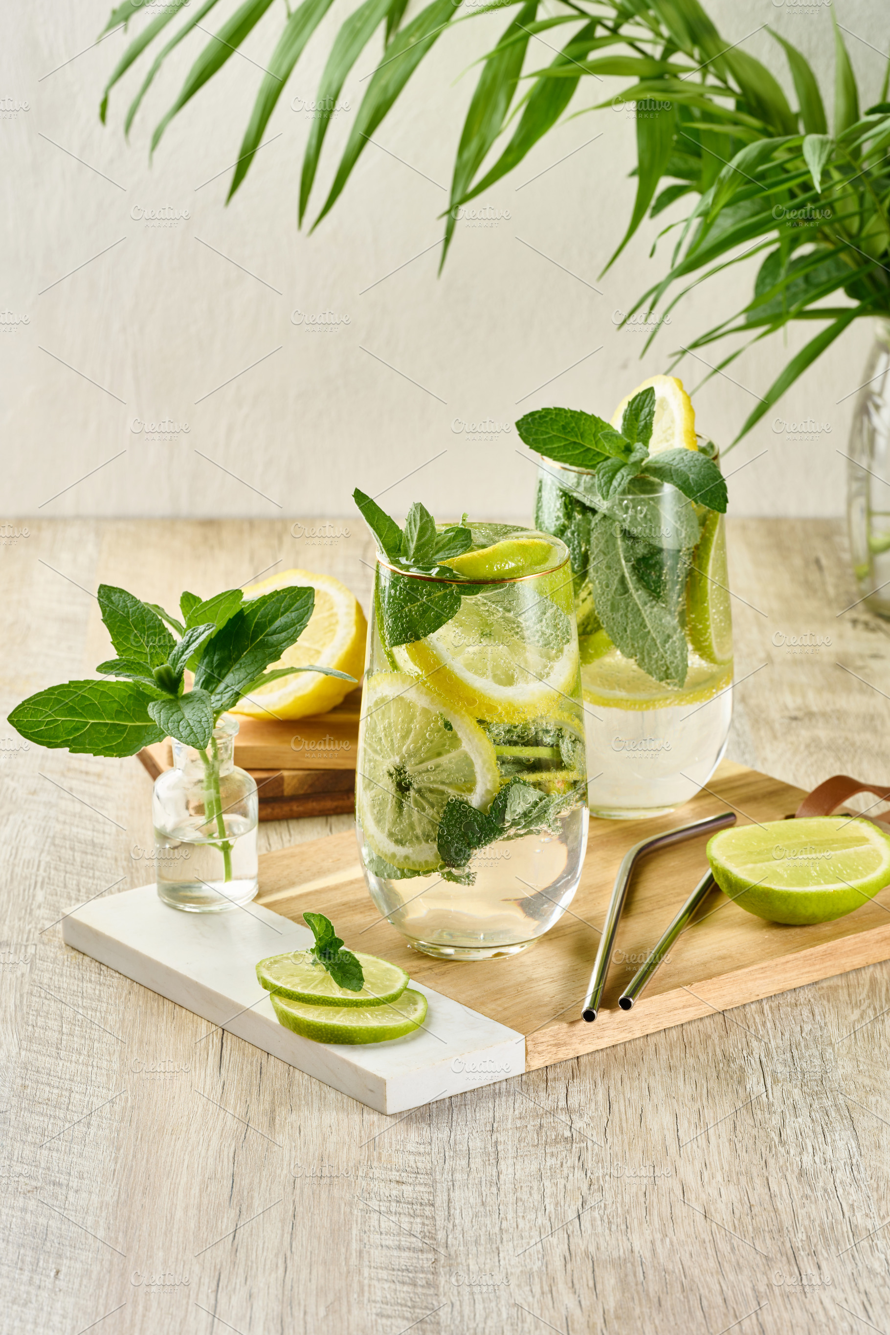 Refreshing citrus and mint drink in glasses with ice, lemon, lim, a Food & Drink Photo by ndanko