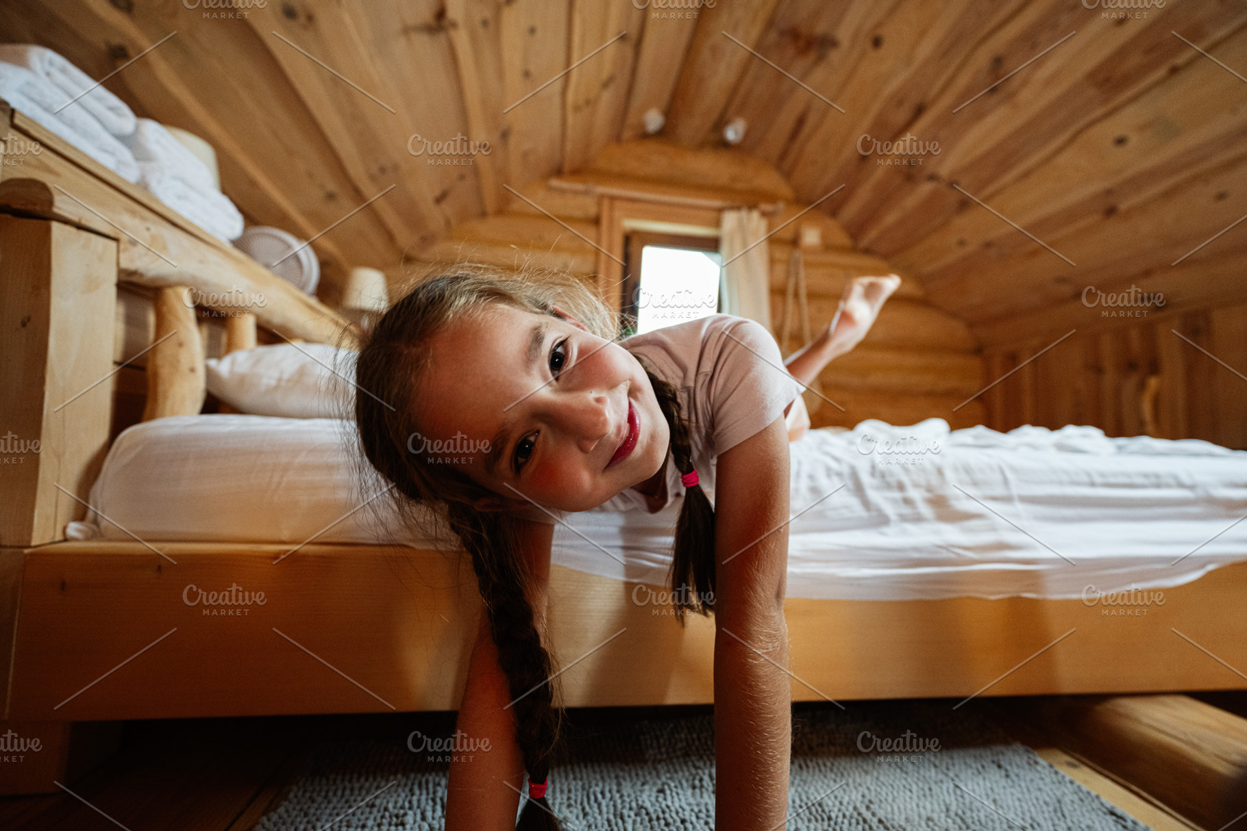 Young girl relaxing in a cozy log cabin with wooden interior decor, a Photo by AS photostudio