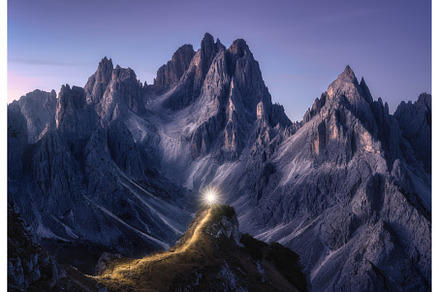 Flashlight trails on mountain path
