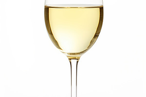 White wine in a glass on white background, a Food & Drink Photo by AlyaAnd