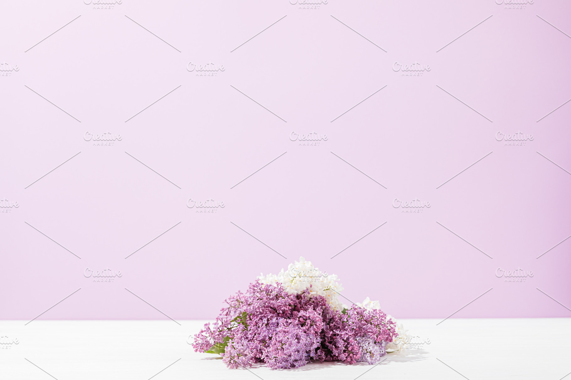 Bunch of fresh lilac flowers lies on white table, a Nature Photo by progressman
