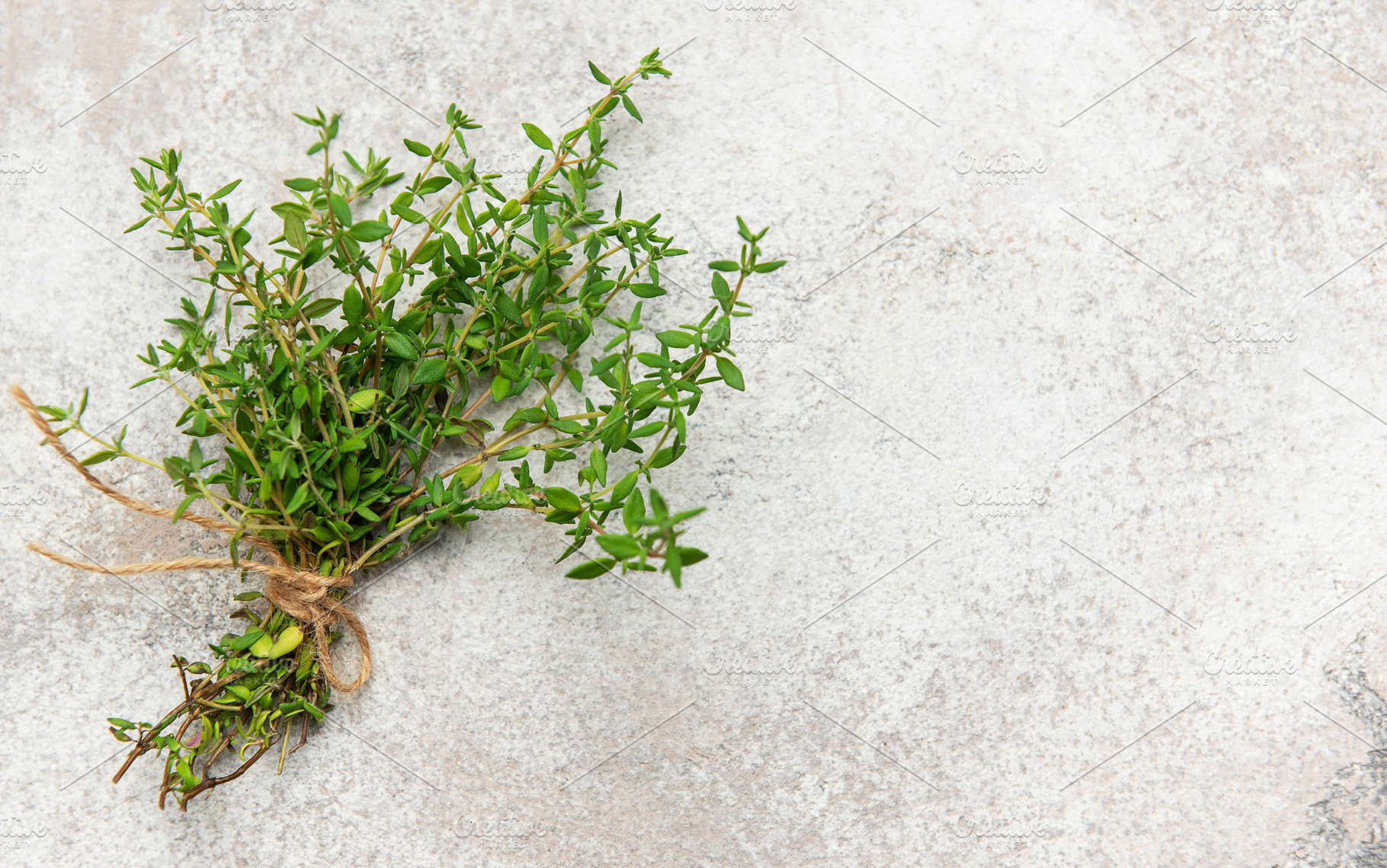 Fresh thyme bunch tied with twine on gray background for culinar, a Food & Drink Photo by Olena Rudo