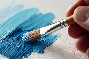 Hand uses a paintbrush to apply blue, an Arts & Entertainment Photo by MistyDay