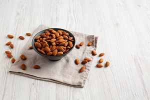 Roasted Almonds in a Bowl, side view. Copy space., a Food & Drink Photo by LiudmylaChuhunova