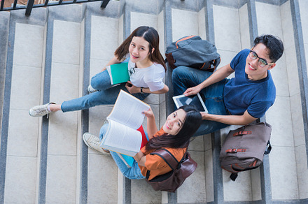 Group of Asian college student using tablet and mobile phone out, a Person Photo by Ministocker