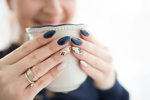 Woman's hands with a cup featuring nails, hands, and cup