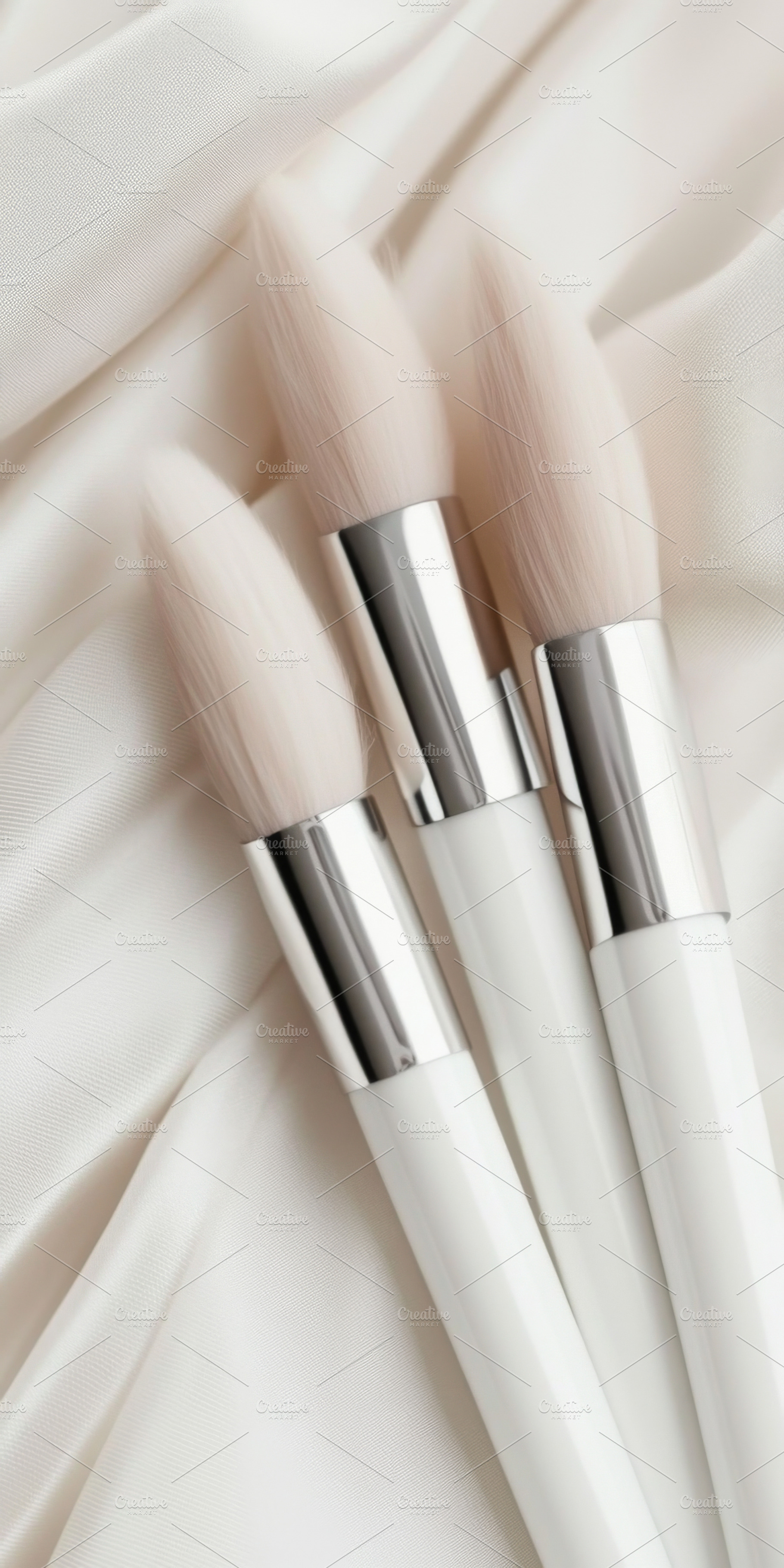 Three makeup brushes arranged, a Photo by Dvoevnore photos