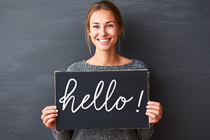Smiling woman holding a blackboard, a Person Photo by MistyDay