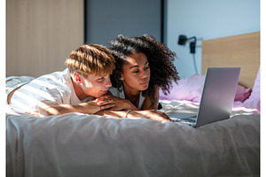 Modern couple enjoying streaming, a Person Photo by HalfPoint